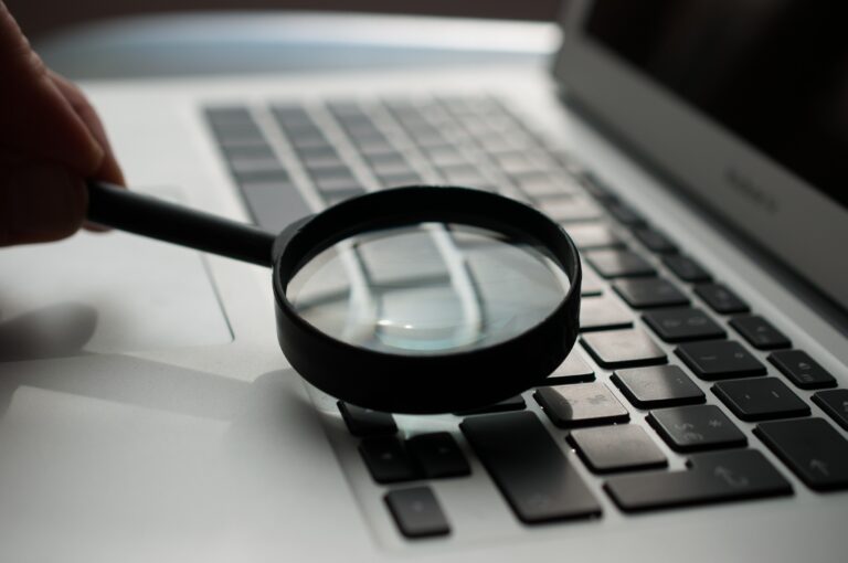 magnifying glass on top of laptop keyboard